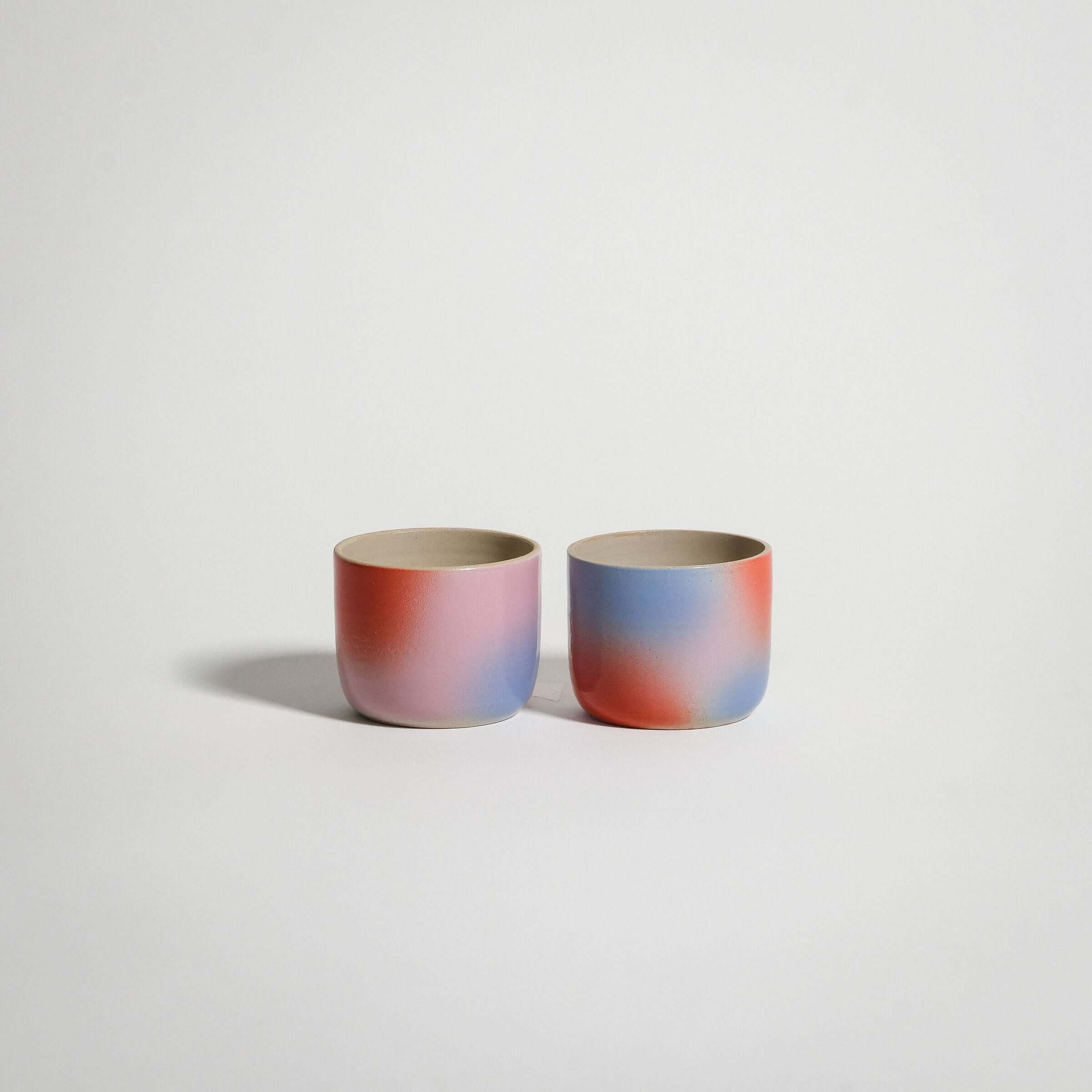 Dawn Espresso Cups in red, blue, and lilac gradient, handcrafted grey stoneware, glossy interior glaze.