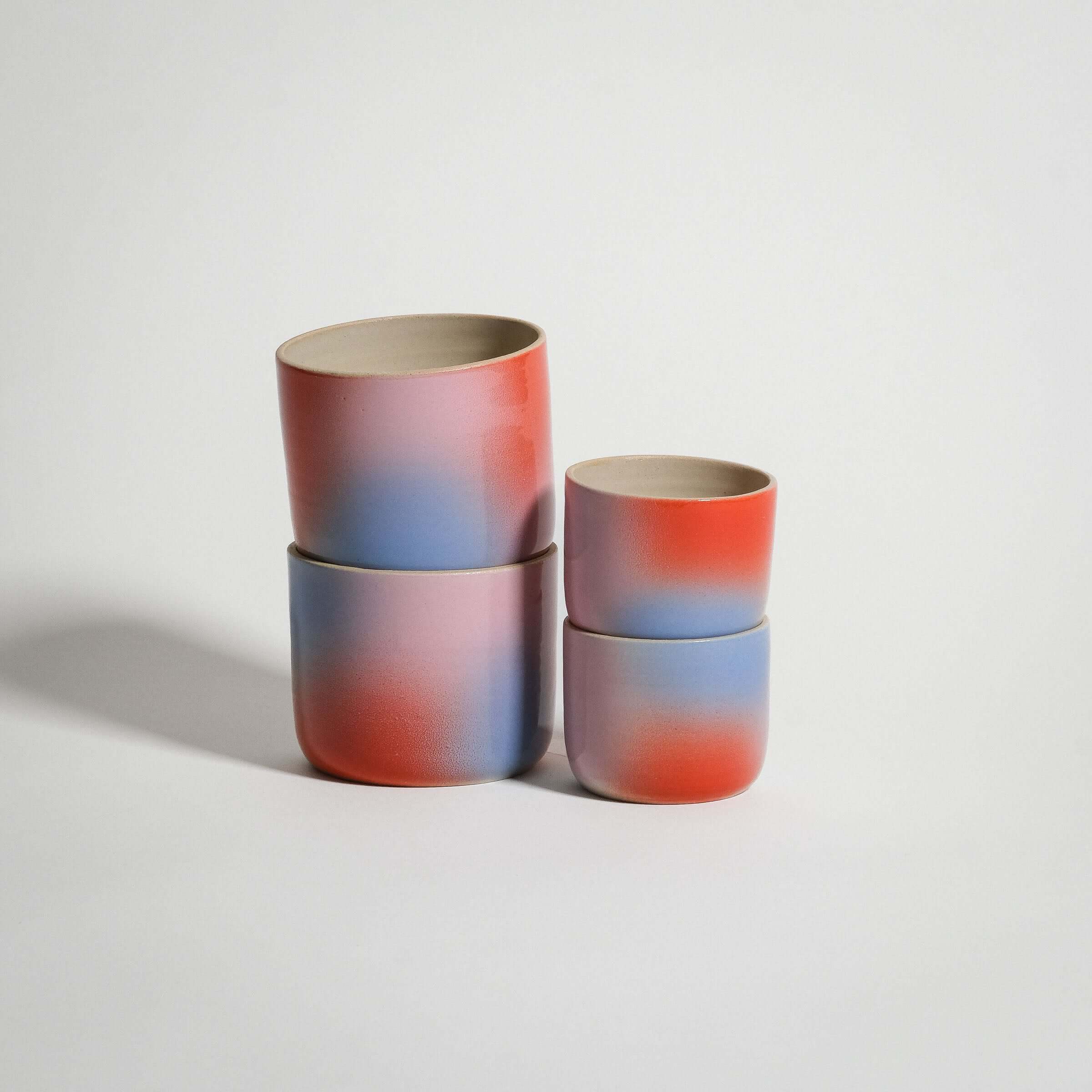 Dawn Espresso & Coffee Cup Set of four handcrafted stoneware cups in red, blue, and lilac gradient finish.