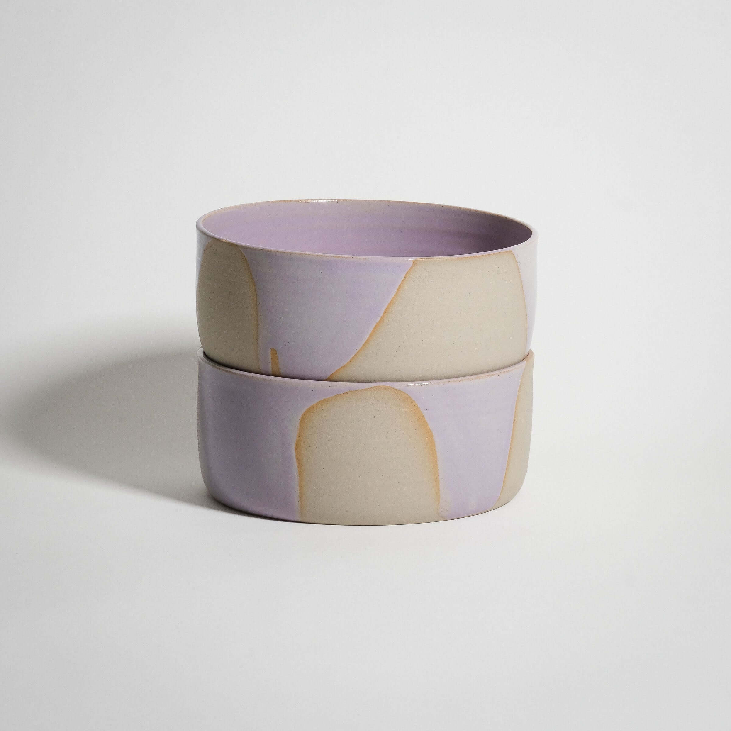 Handcrafted lilac stoneware breakfast bowl with glossy pink glaze interior, ideal for serving soups and granola.