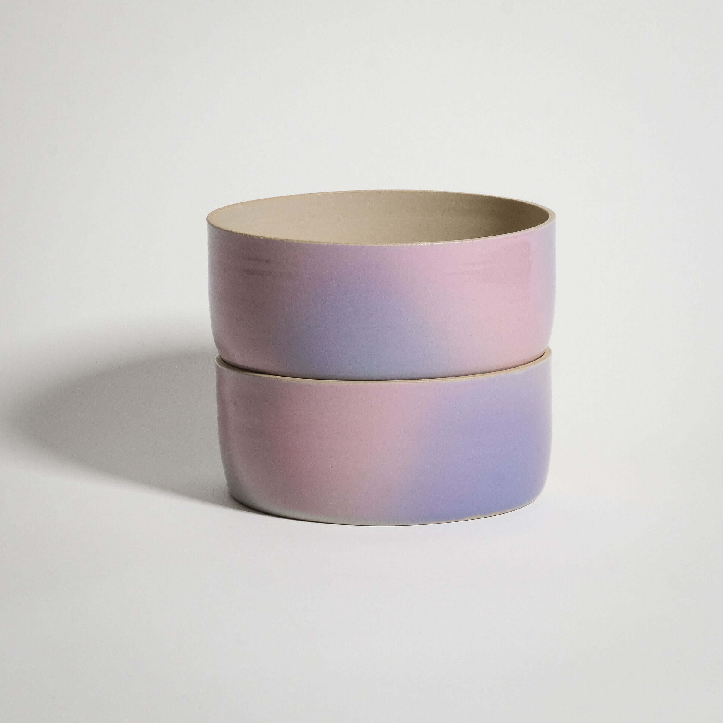 Handcrafted lilac and pink stoneware breakfast bowl with glossy glaze, stacked view on a neutral background.