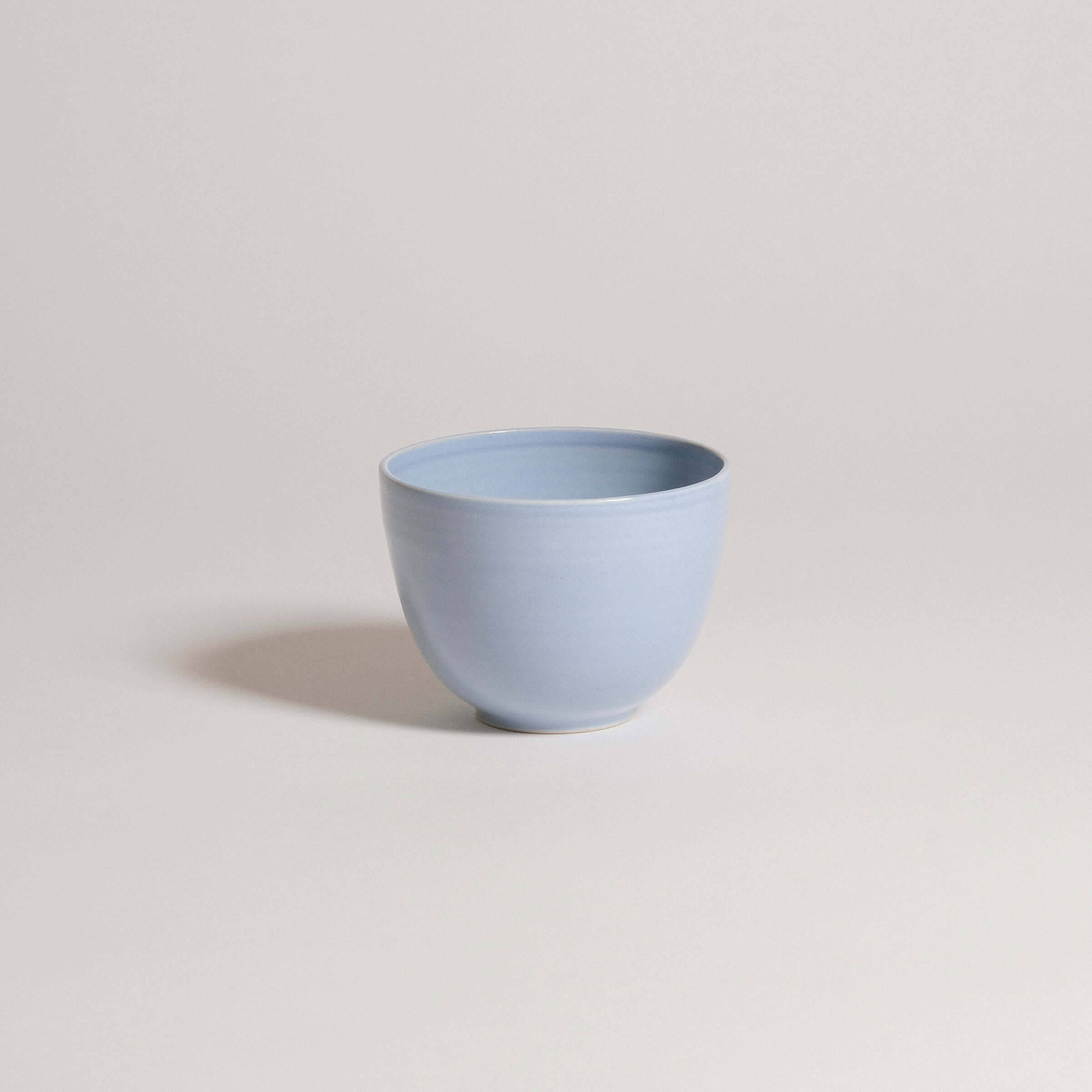 Blue stoneware coffee cup, glossy finish, modern design, perfect for drinks and stylish decor.
