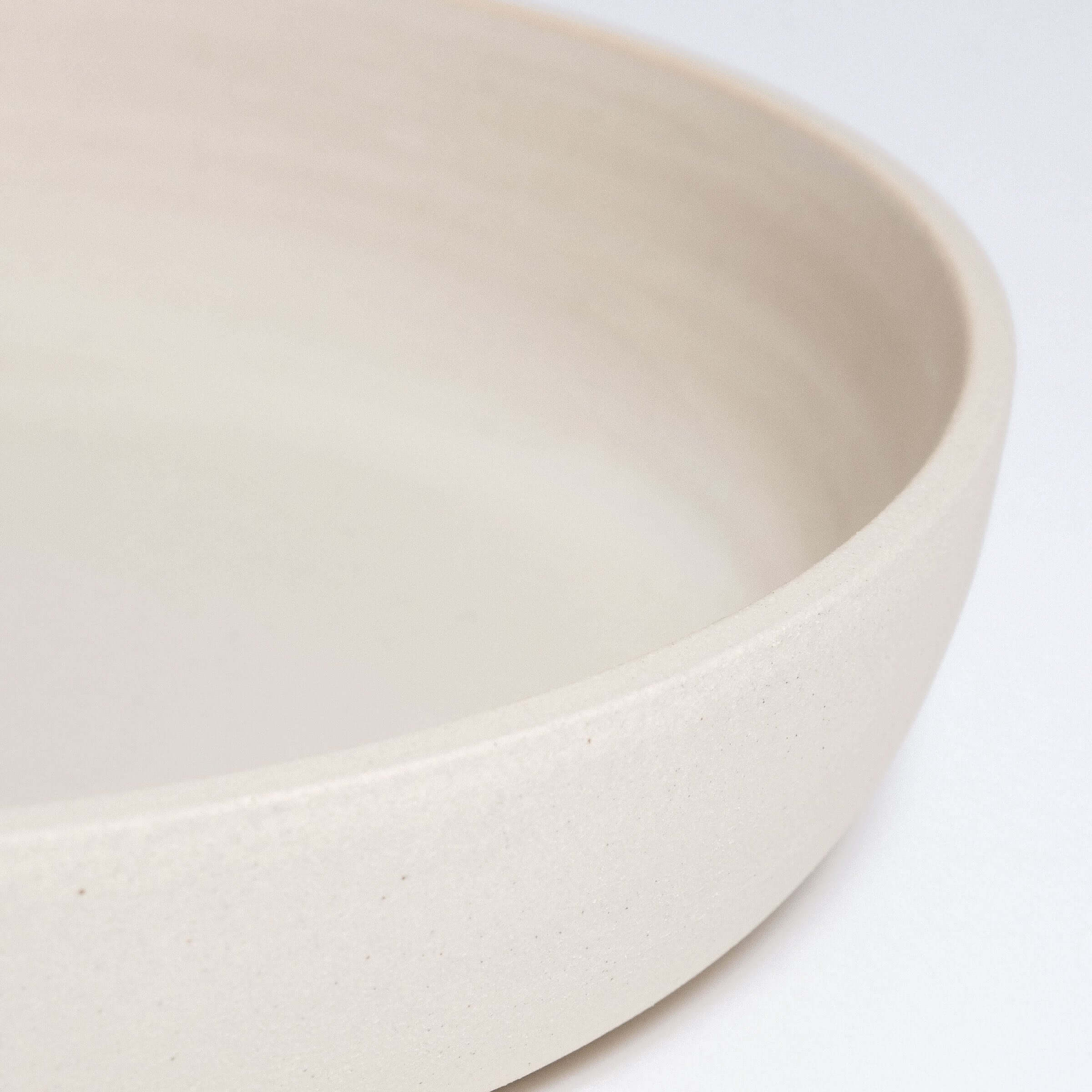 Handcrafted stoneware dinner bowl in creme with a smooth, elegant finish, perfect for everyday dining.