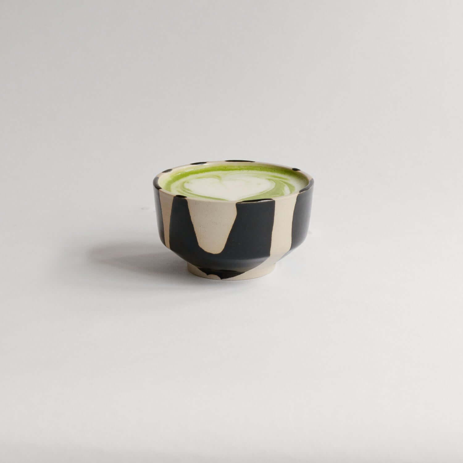 Matcha Set – Otis handcrafted pouring bowl containing vibrant matcha drink.