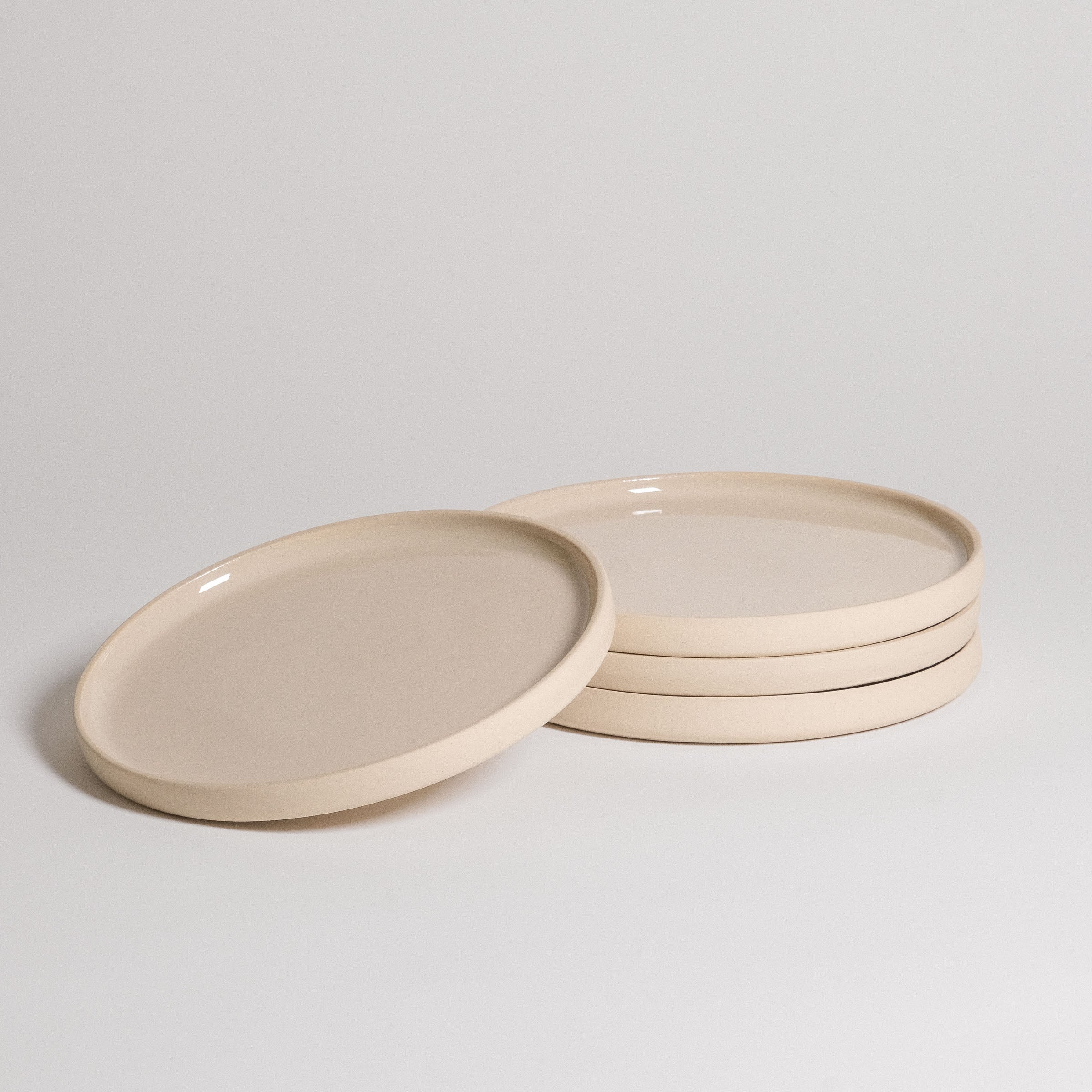 Mix & Match - Plate Bundle featuring a set of stacked elegant beige plates for versatile dining options.