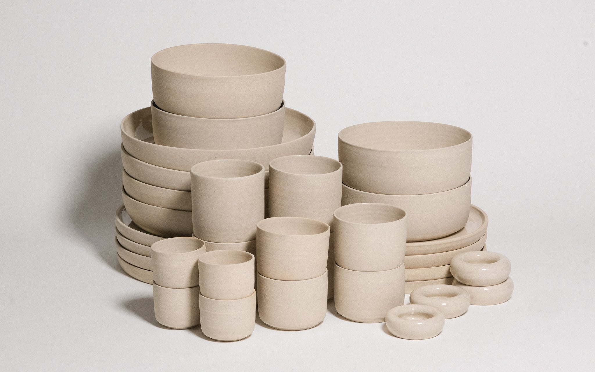 Mix & Match - Tableware Bundle featuring a variety of neutral-toned bowls and cups arranged artistically.