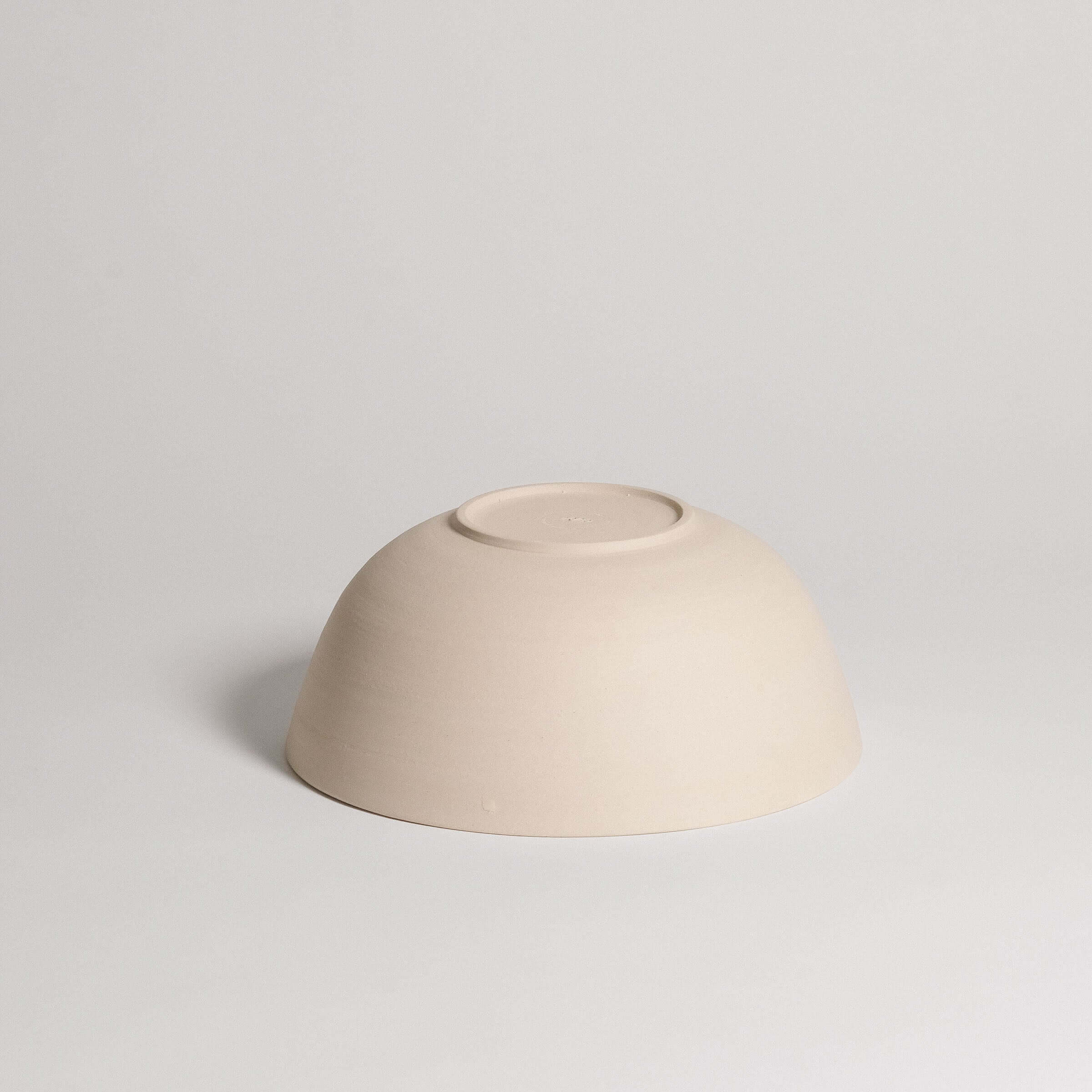 Ramen bowl in grey stoneware clay with glossy glaze on the inside and raw finish outside, perfect for serving.