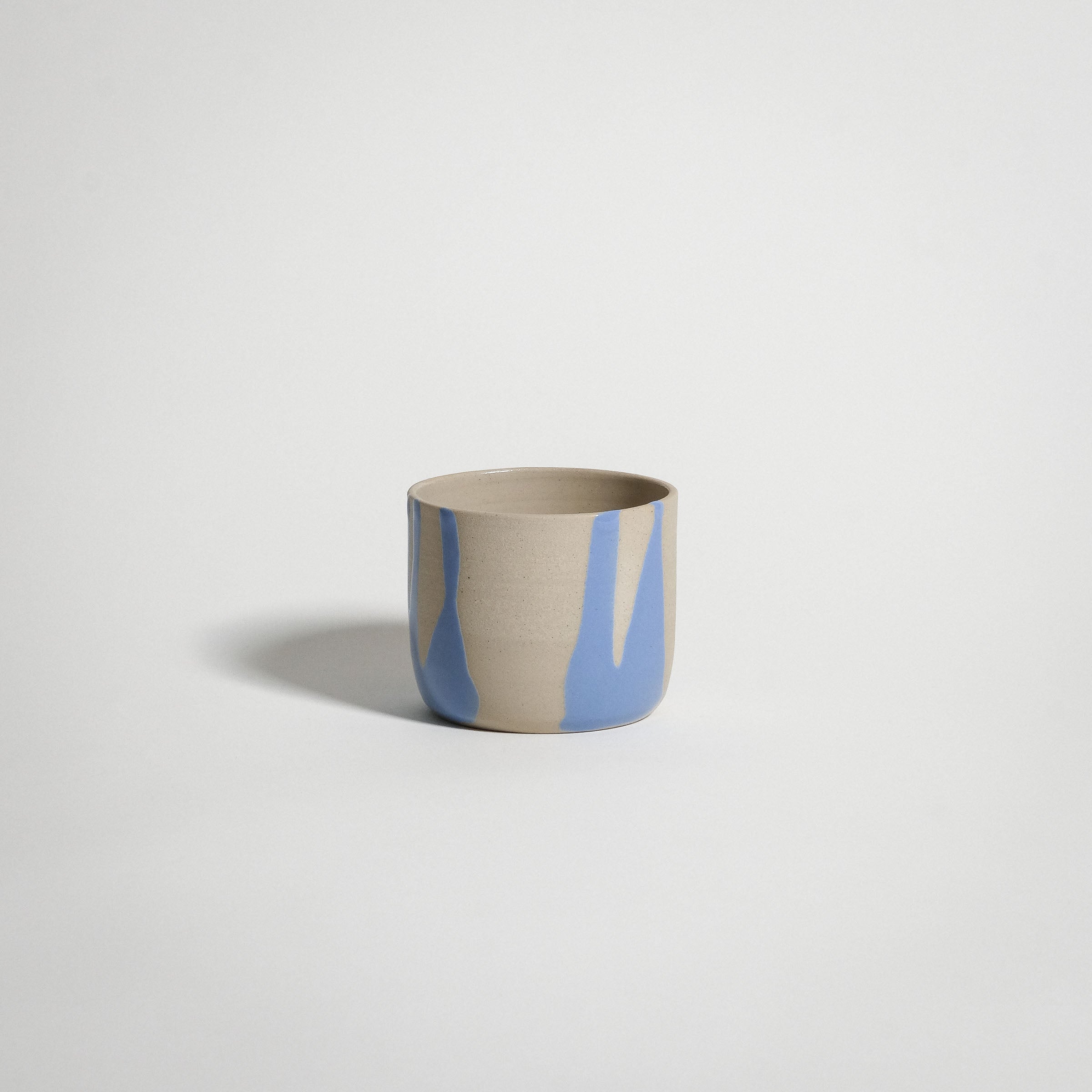 Handcrafted Splash Blue coffee cup, wheel-thrown from grey stoneware clay, perfect for warm beverages.