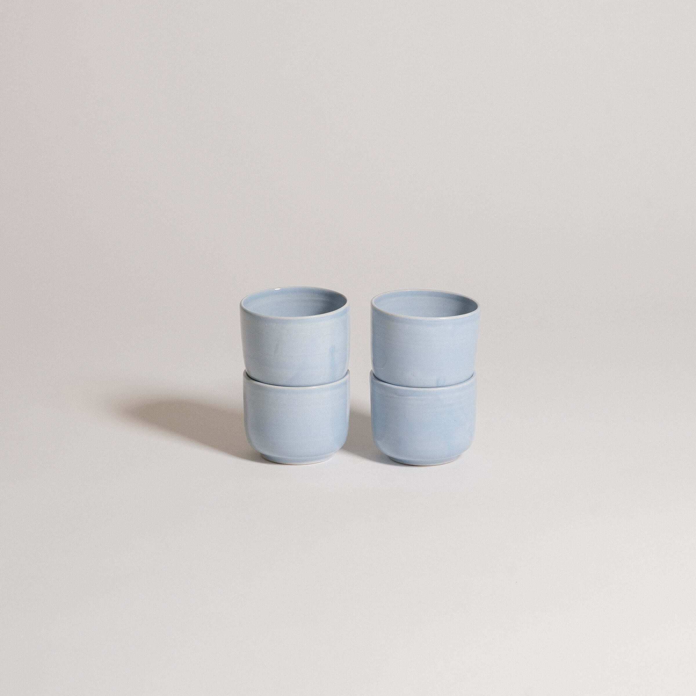Set of 4 handcrafted stoneware espresso cups in Iceblue glaze, perfect for daily use and food-safe.