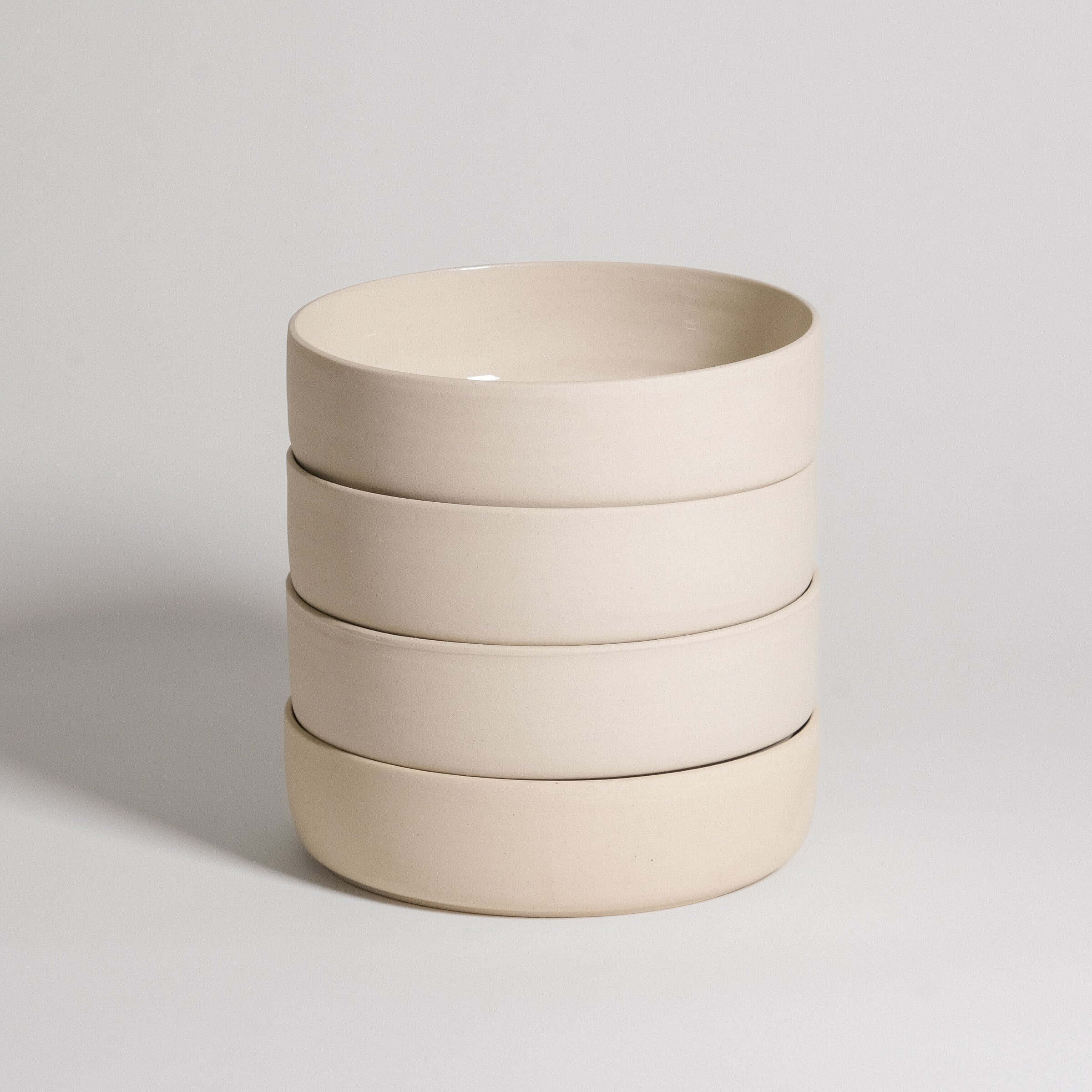 Set of 4 Nomi Creme pasta bowls made from grey stoneware with glossy glaze interior and raw exterior.