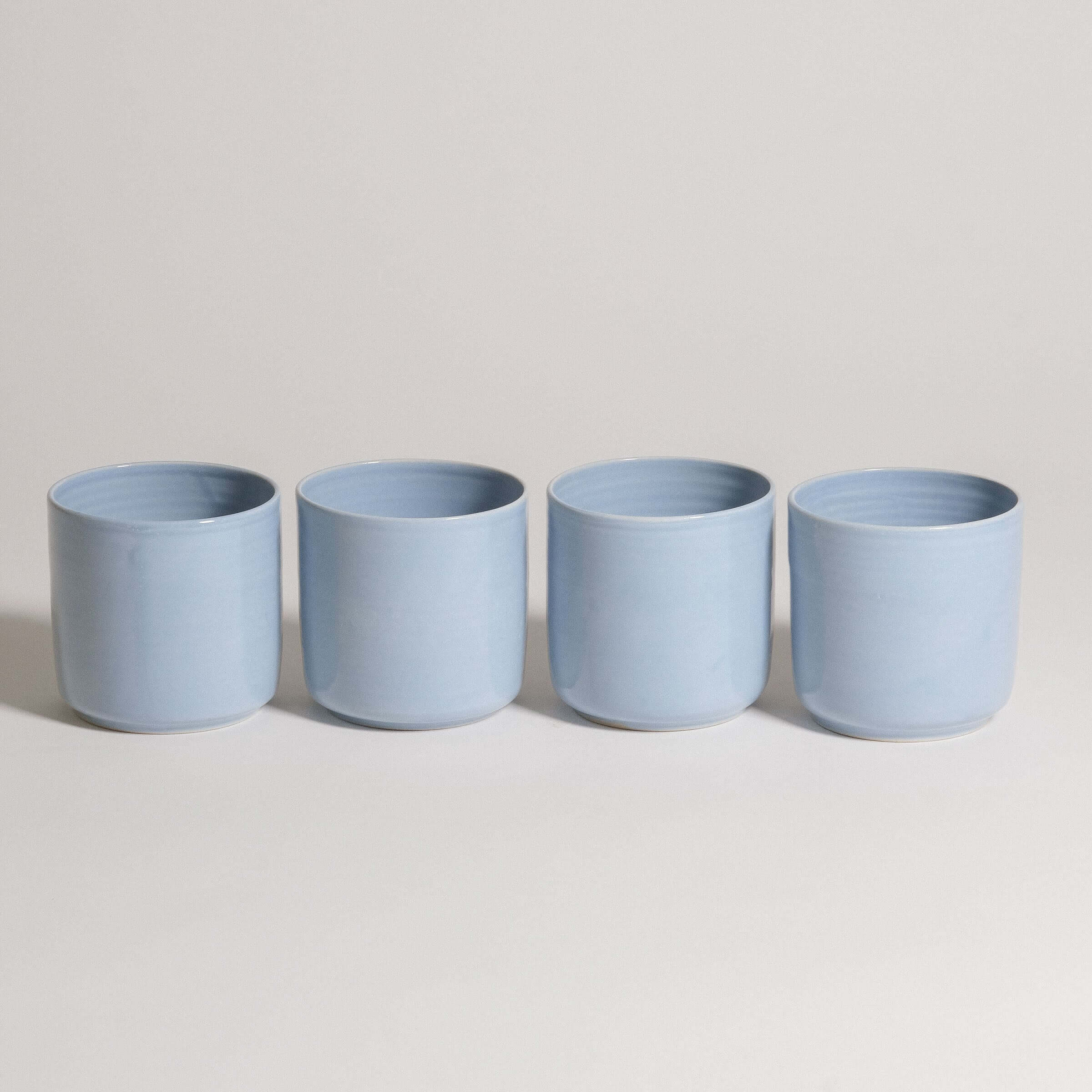 Set of 4 Nomi Iceblue handcrafted tea cups in durable ceramic, showcasing a unique iceblue glaze.