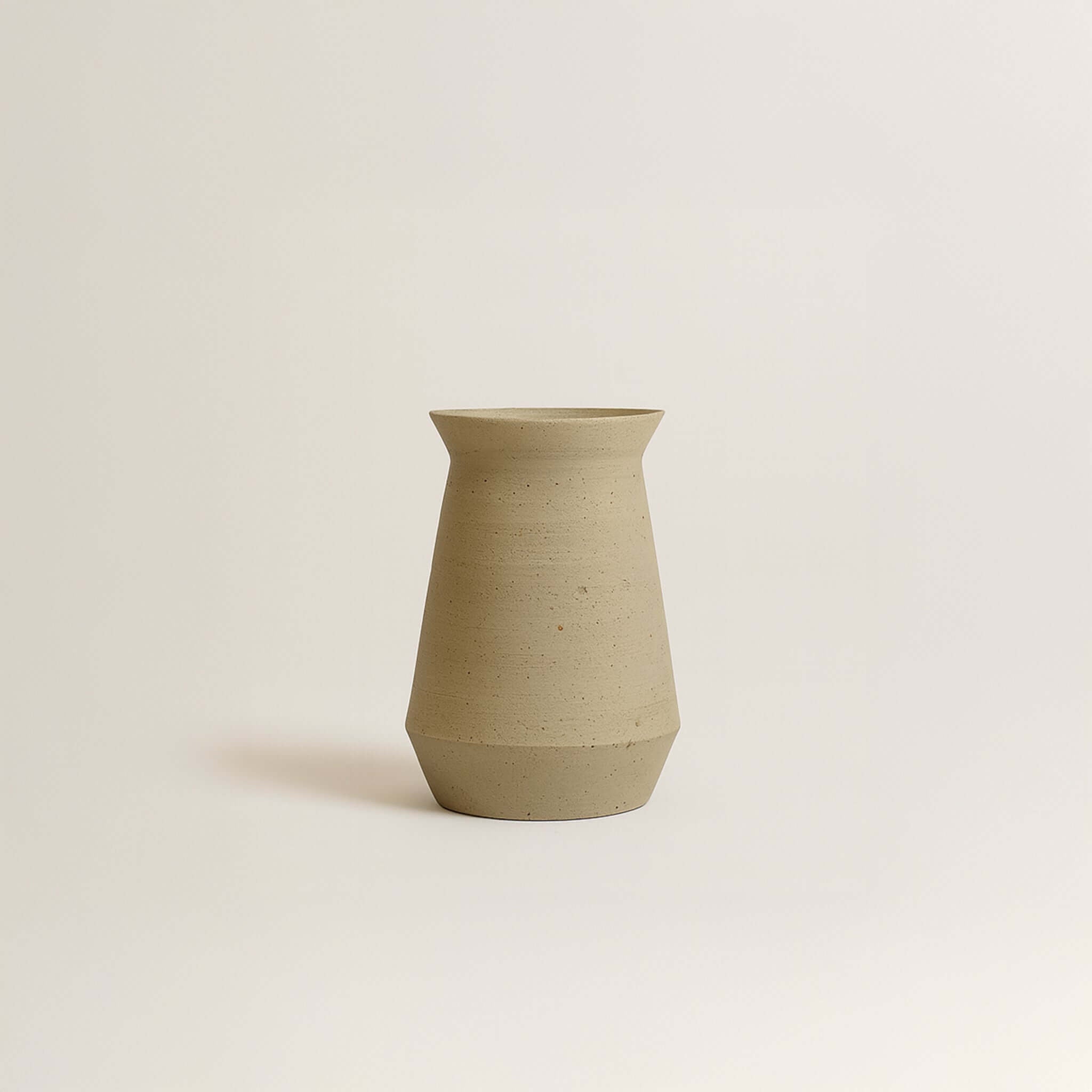 Handcrafted stoneware wine carafe in beige, showcasing unique textures and earthy tones, perfect for serving wine.