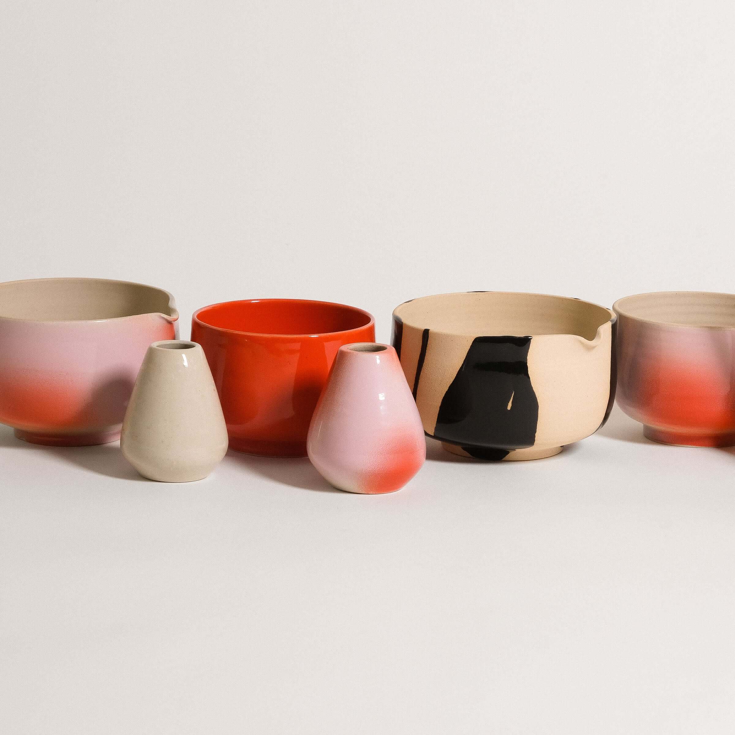 Handcrafted Matcha Collection featuring colorful stoneware bowls and vases with unique airbrush finishes.