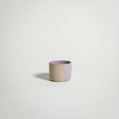 Handcrafted lilac espresso cup in grey stoneware, featuring glossy pink and transparent glazes.