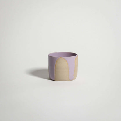 Handcrafted wheel-thrown lilac coffee cup in grey stoneware with pink glossy exterior glaze.