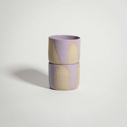 Handcrafted wheel-thrown lilac coffee cup with pink glossy glaze, ideal for tea or warm beverages.