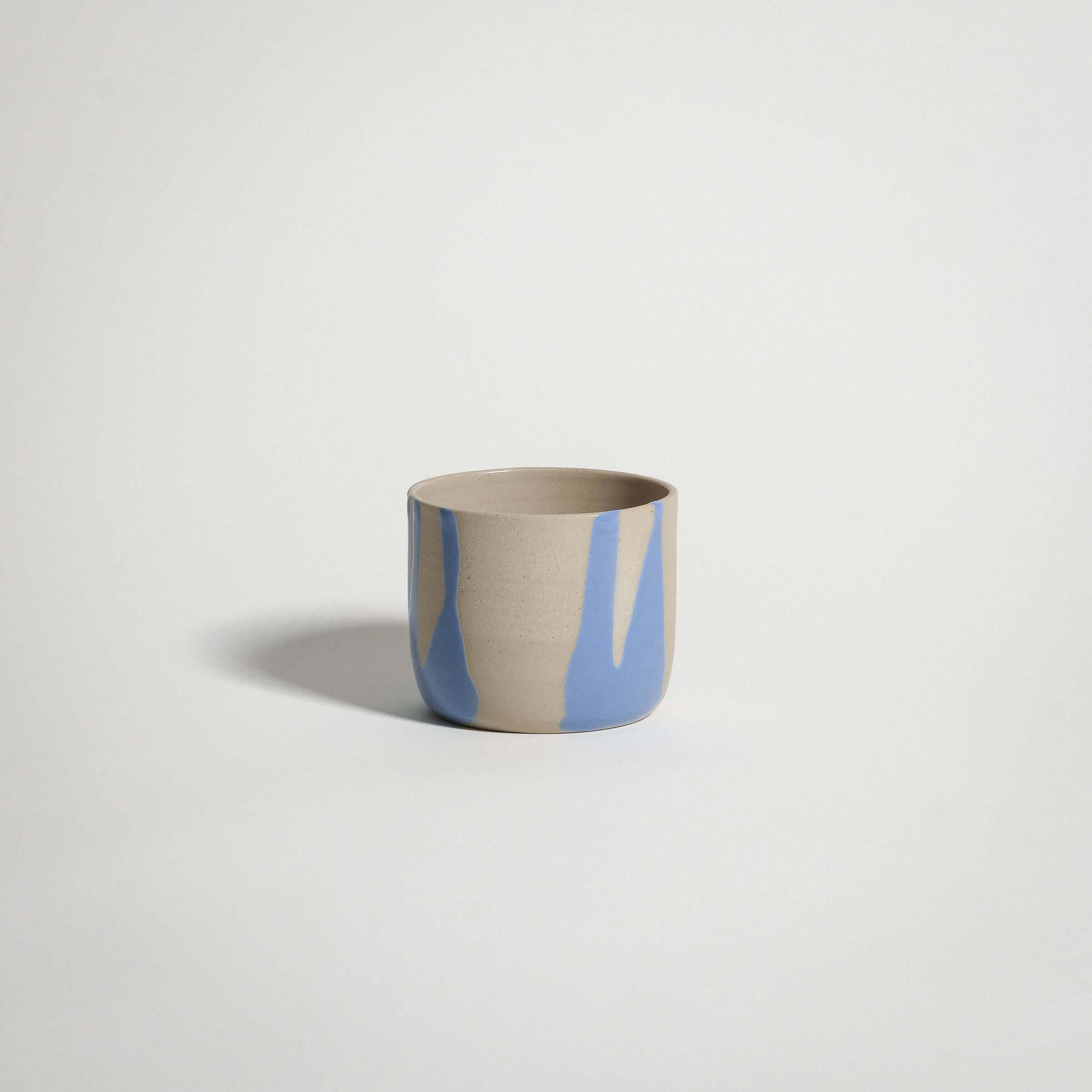 Handcrafted blue stoneware coffee cup with glossy glaze, perfect for tea or warm beverages.