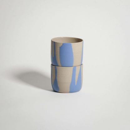 Handcrafted wheel-thrown blue stoneware coffee cup with glossy glaze, ideal for warm beverages.