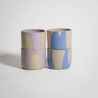 Handcrafted grey stoneware coffee cup set featuring lilac and light blue glossy finishes.