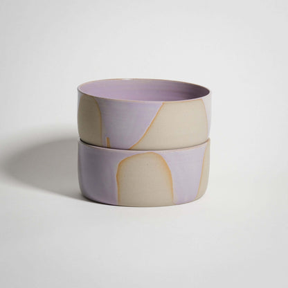 Handcrafted lilac stoneware breakfast bowl with glossy pink glaze interior, ideal for serving soups and granola.