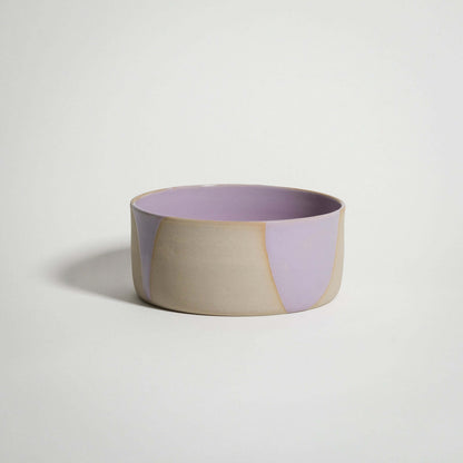 Handcrafted lilac splash breakfast bowl with glossy pink glaze interior and grey stoneware exterior.
