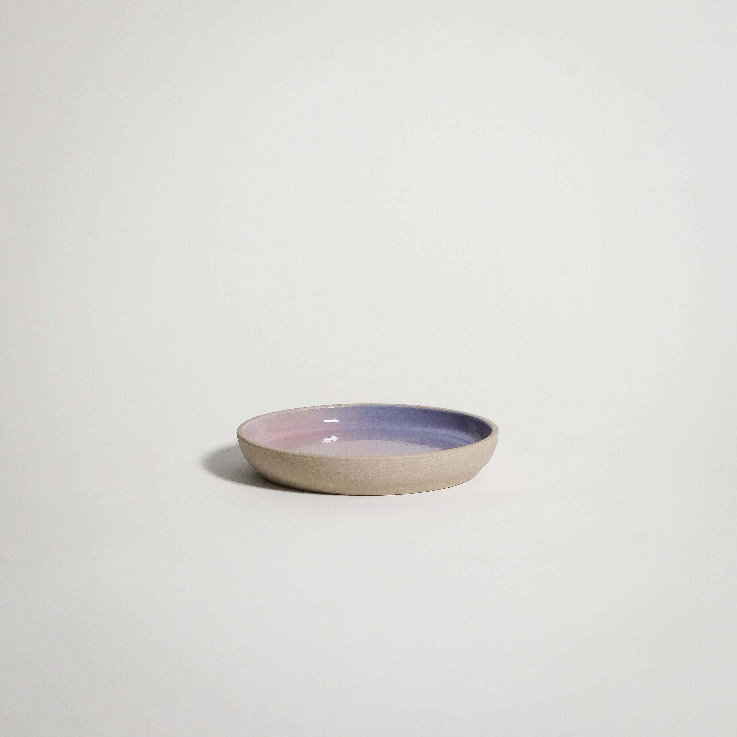 Handcrafted grey stoneware small plate with lilac and pink spray-painted fade, perfect as a saucer or for palo santo.