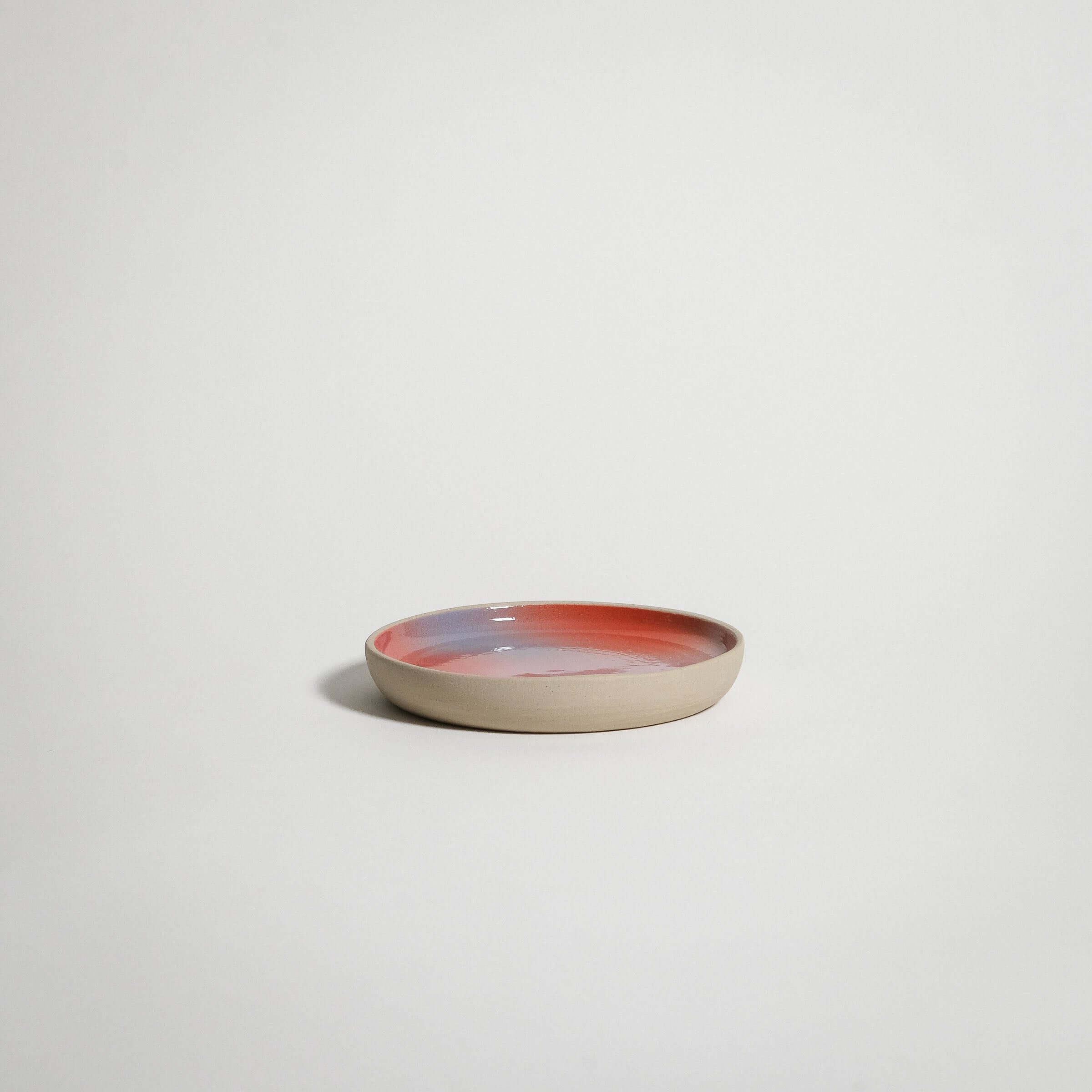 Dawn Catch All small plate, handcrafted grey stoneware with red, blue, and lilac gradient finish.