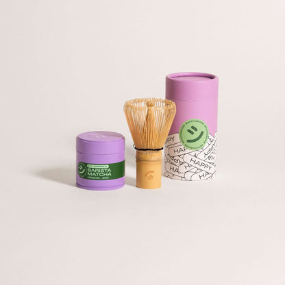 Matcha set featuring barista-grade matcha, bamboo whisk, and vibrant purple packaging for a delightful tea experience.