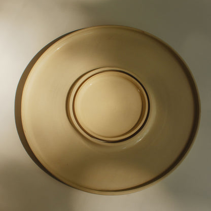 Top view of a cream-colored ceramic tapas tray, featuring a glossy interior and raw exterior texture.