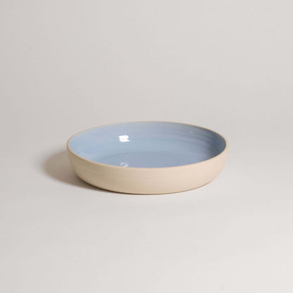 Handcrafted ice blue dinner bowl made from durable stoneware ceramic with a transparent glaze for elegance.