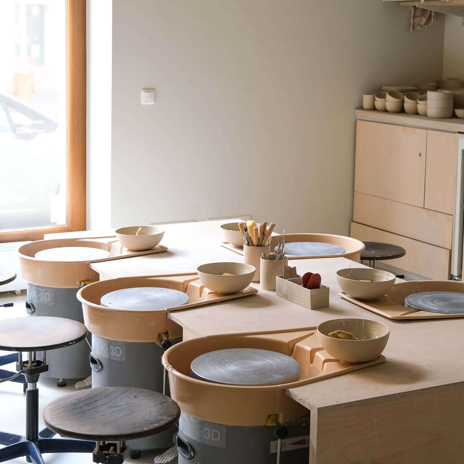 Gift Making Class setup with pottery wheels and materials for creative sessions.