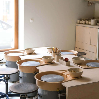 Gift Making Class setup with pottery wheels and materials for creative sessions.