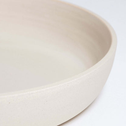 Handcrafted stoneware dinner bowl in creme with a smooth, elegant finish, perfect for everyday dining.