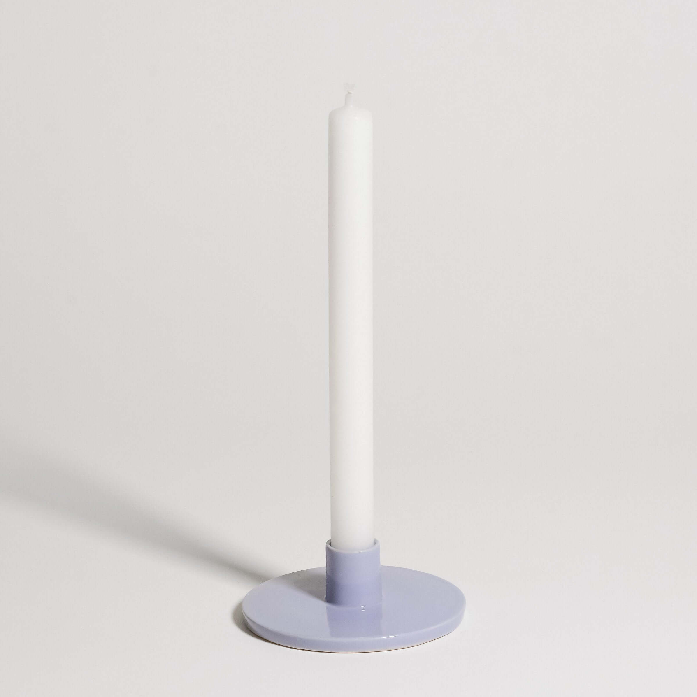 Candle Holder – Lilac displaying a white candle on a soft lilac base, perfect for contemporary interiors.