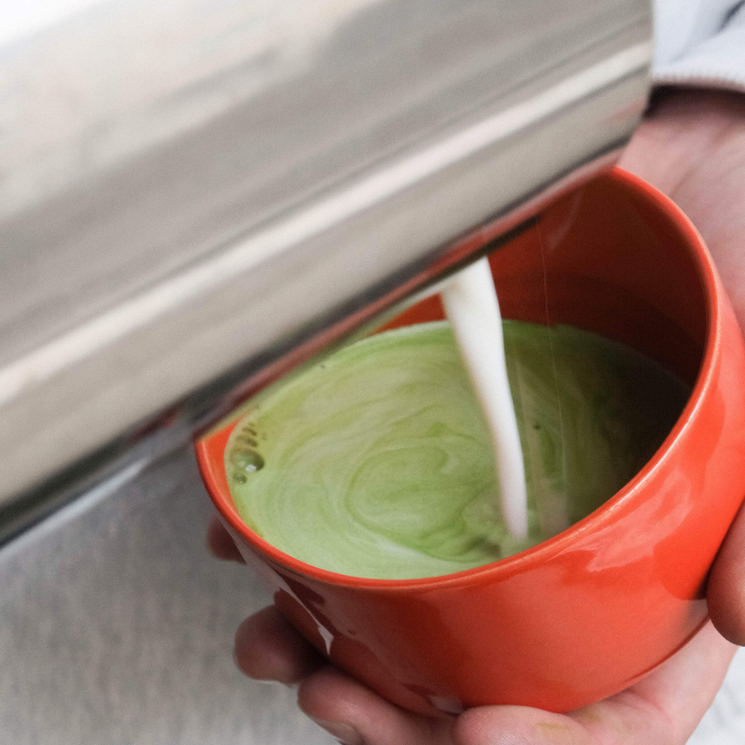 Matcha Set – Classic - Organic Ceremonial Matcha Supreme being prepared with milk in a glossy red matcha cup.