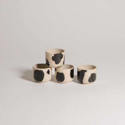 Mix & Match - Cup & Mug Bundle featuring four unique ceramic cups with black and beige designs.