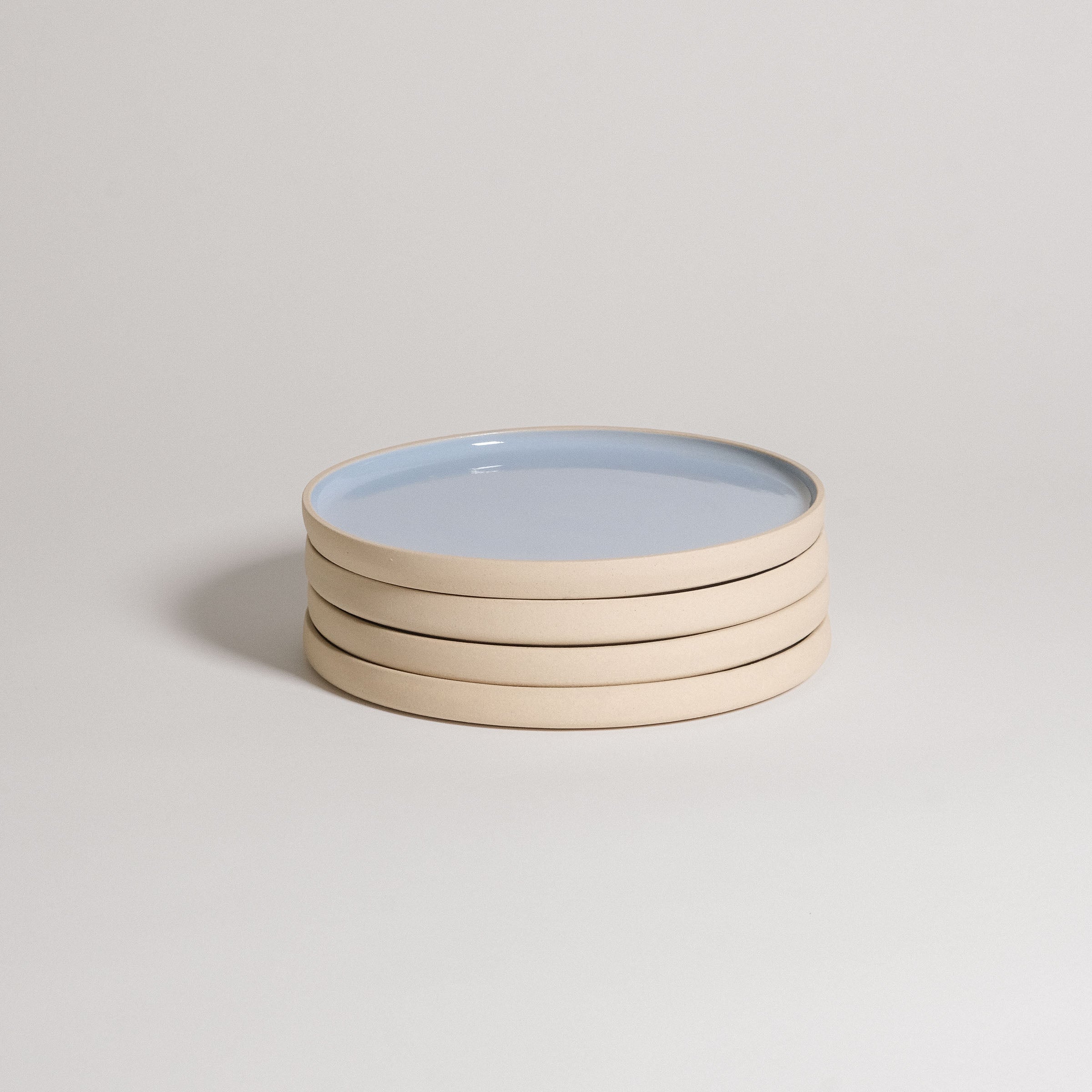 Mix & Match - Plate Bundle featuring stacked light blue and beige plates for versatile dining options.