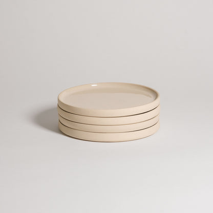Mix & Match - Plate Bundle of four elegant beige plates stacked together, perfect for customizable tableware.