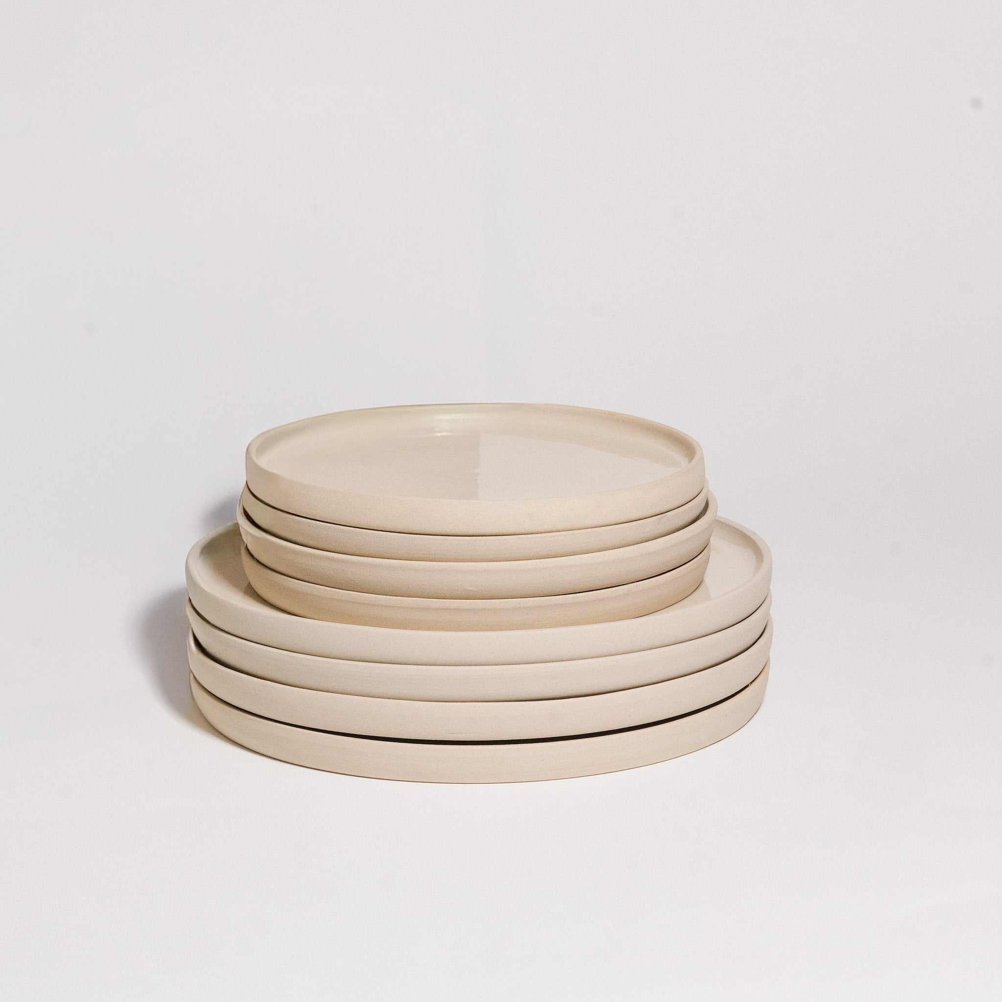 Mix & Match - Plate Bundle featuring a stack of elegant beige dinner plates.