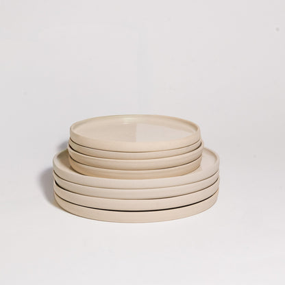 Mix & Match - Plate Bundle featuring a stack of elegant beige dinner plates.