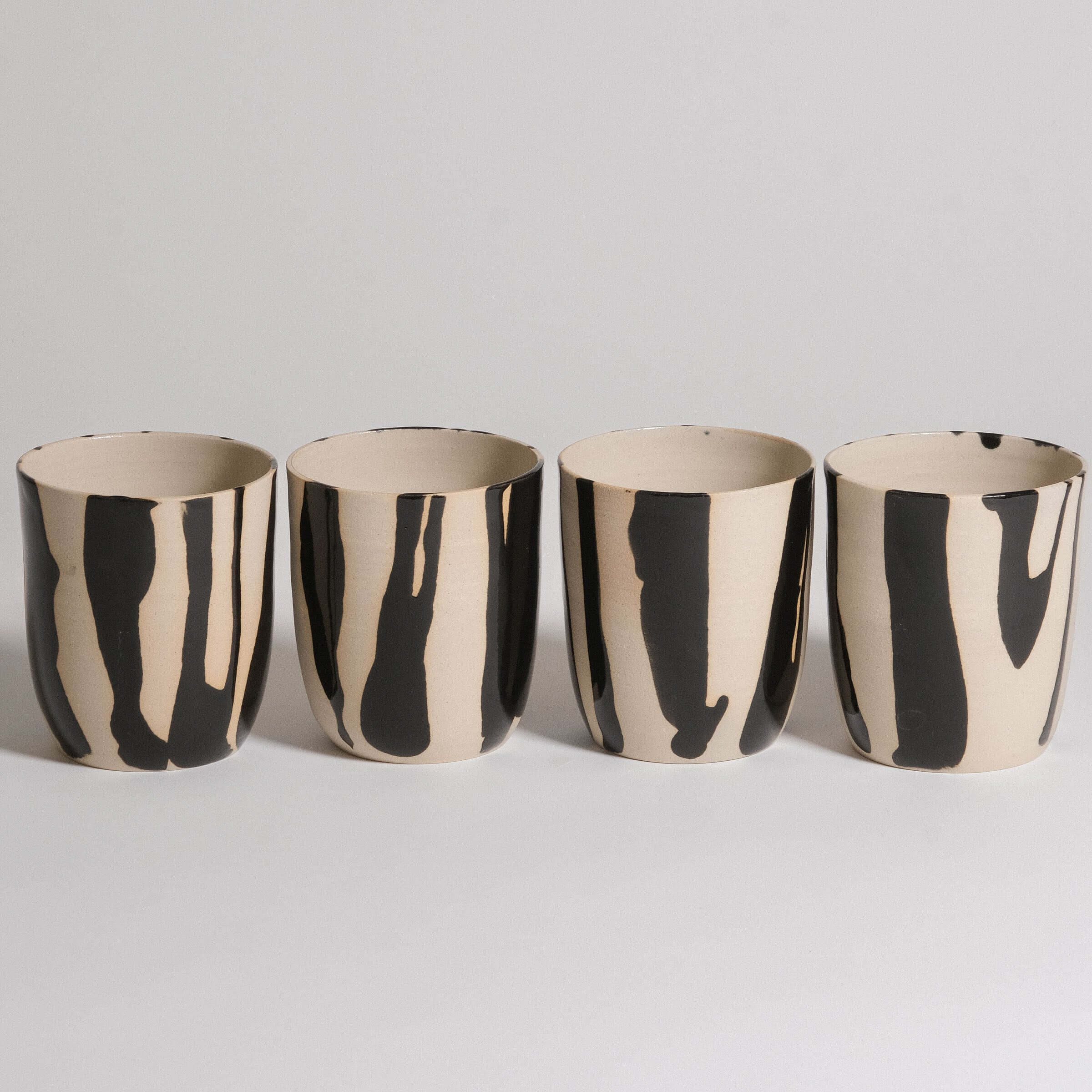 Mix & Match - Cup & Mug Bundle featuring four stylish black and white striped cups.