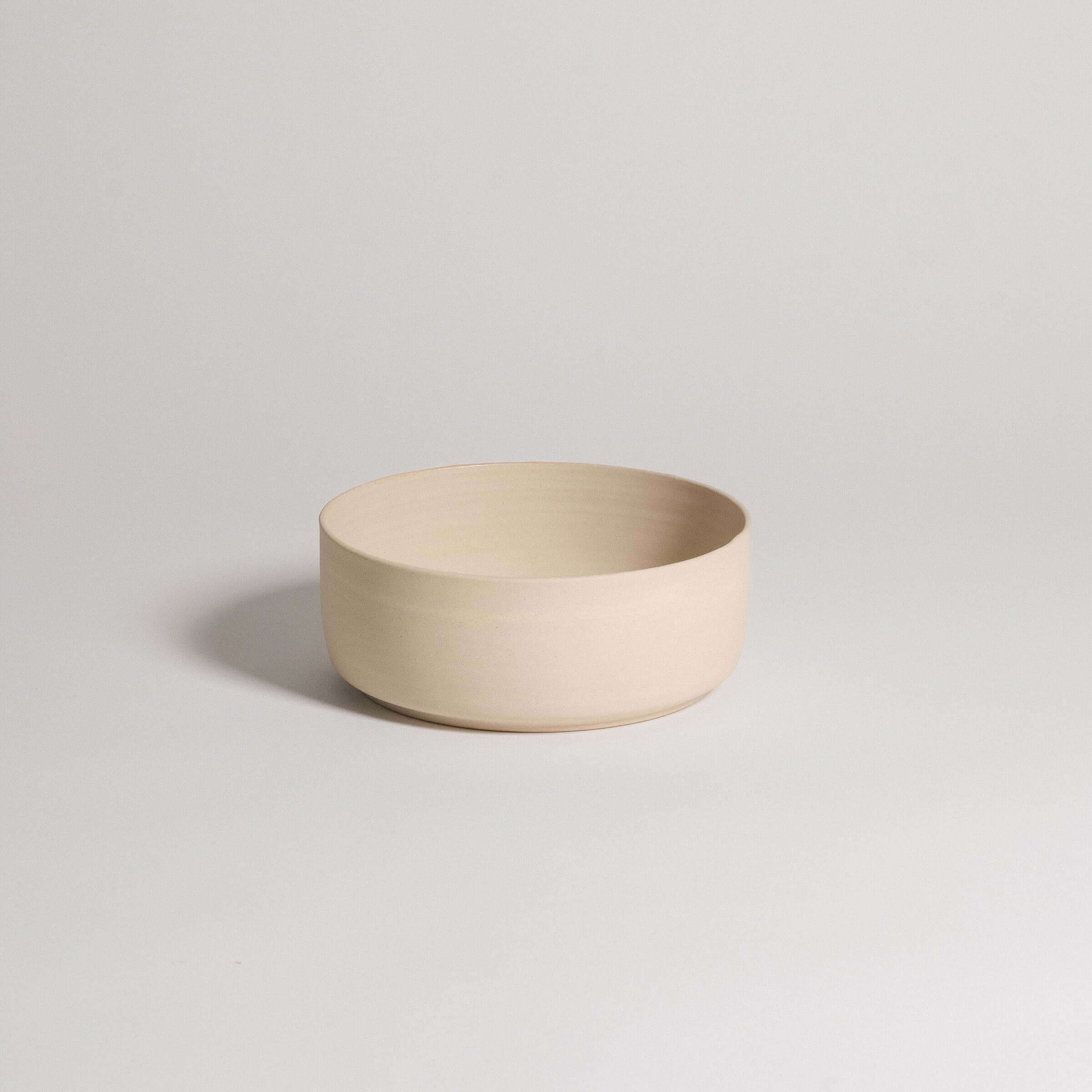 Set of 4 Nomi Creme breakfast bowls in grey stoneware with glossy glaze inside and raw exterior.