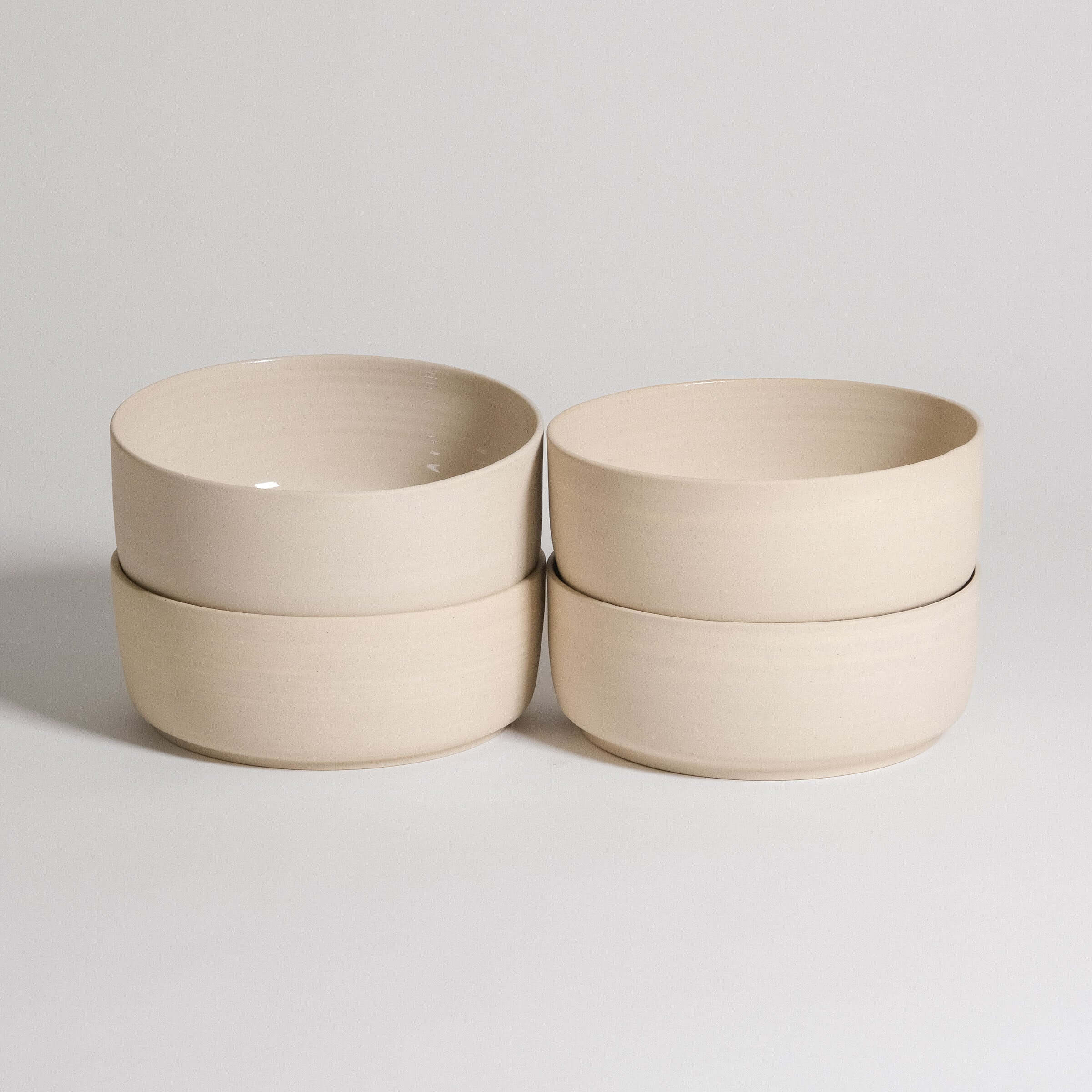 Set of 4 Nomi Creme breakfast bowls made from grey stoneware with a glossy interior and raw exterior.