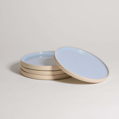 Set of 4 handcrafted stoneware breakfast plates in Iceblue glaze, showcasing unique character and food-safe design.