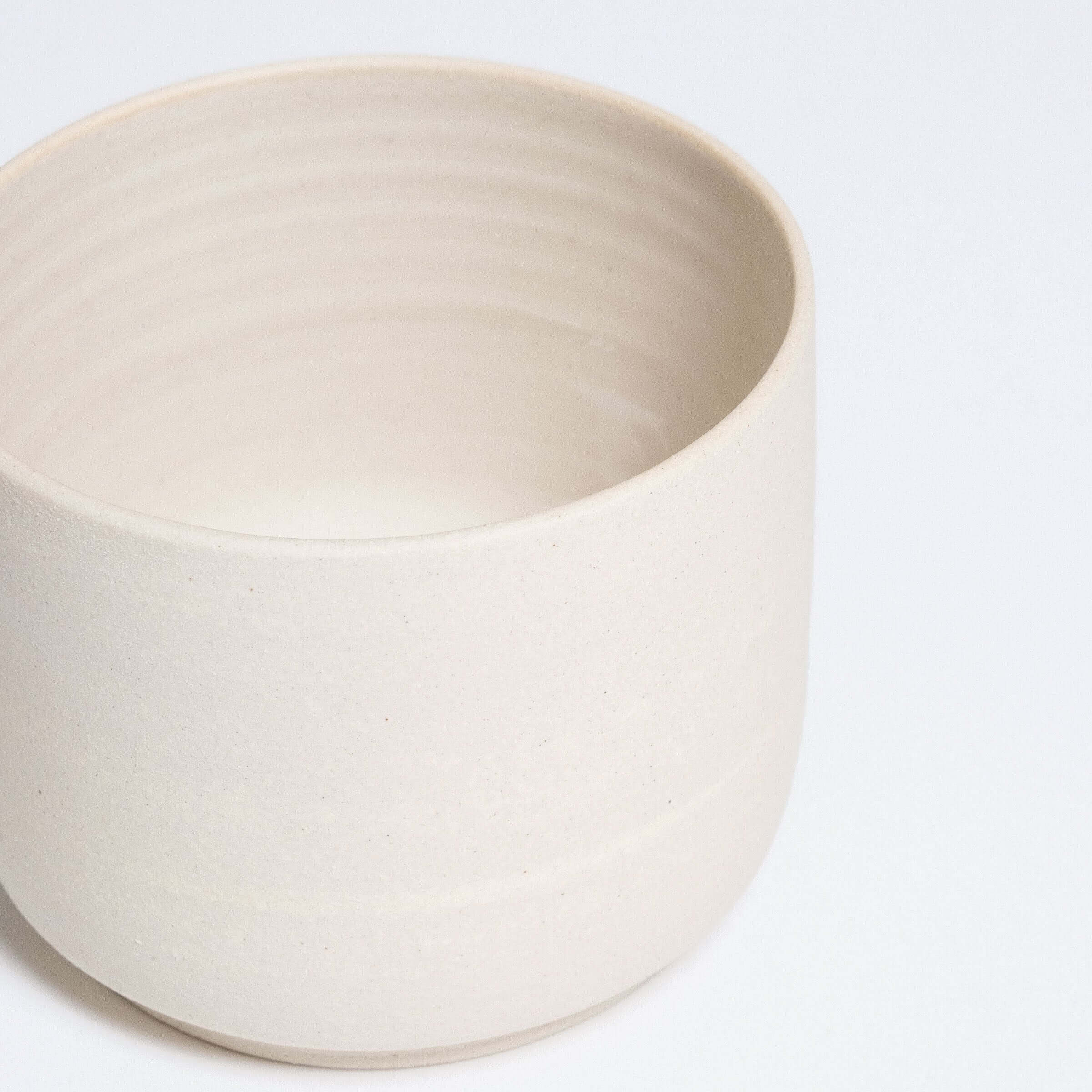 Set of 4 Nomi Creme coffee cups in grey stoneware, featuring a glossy interior and raw exterior.