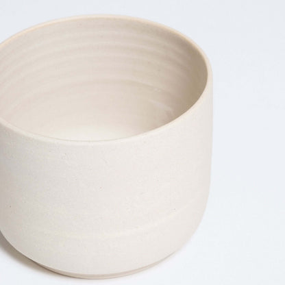 Set of 4 Nomi Creme coffee cups in grey stoneware, featuring a glossy interior and raw exterior.