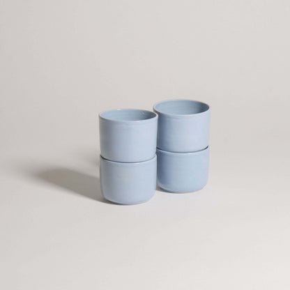Set of 4 Nomi Iceblue coffee cups, handcrafted stoneware ceramic, showcasing unique iceblue glaze finish.