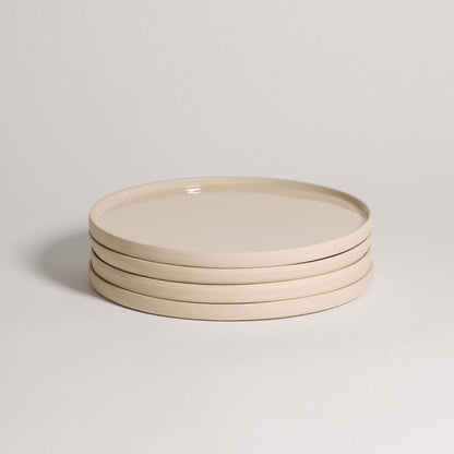 Set of 4 handcrafted creme dinner plates made from durable stoneware ceramic, featuring a unique transparent glaze.