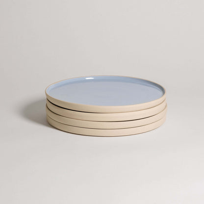 Set of 4 iceblue dinner plates stacked, handcrafted from durable stoneware ceramic, showcasing a unique glaze.
