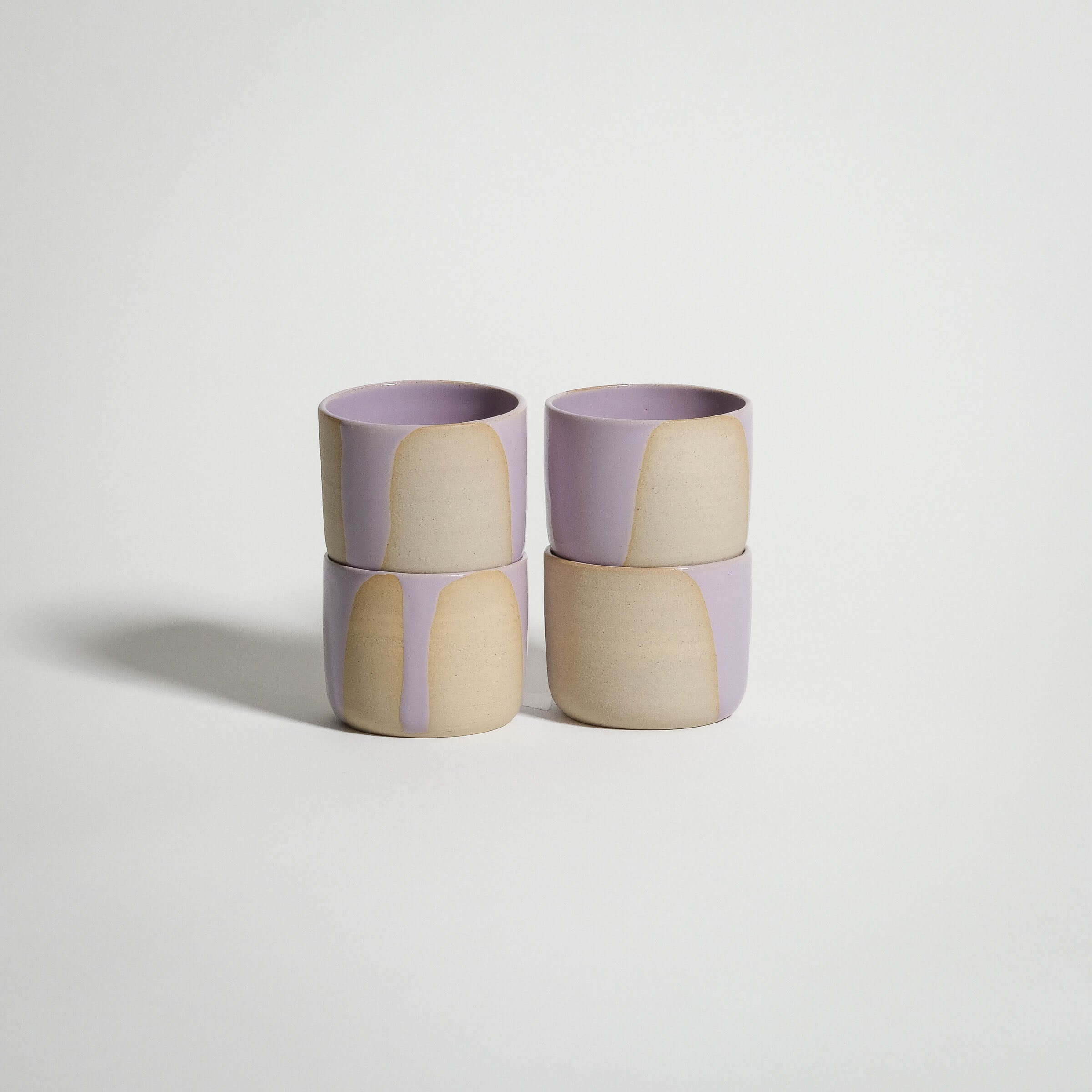 Set of 4 handcrafted espresso cups in Splash Lilac, showcasing a glossy pink and beige glaze design.