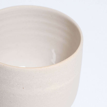Set of 4 Nomi Creme espresso cup in grey stoneware with glossy interior and raw exterior.